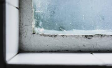 closeup shot wild windowsill with old window glass covered frosting