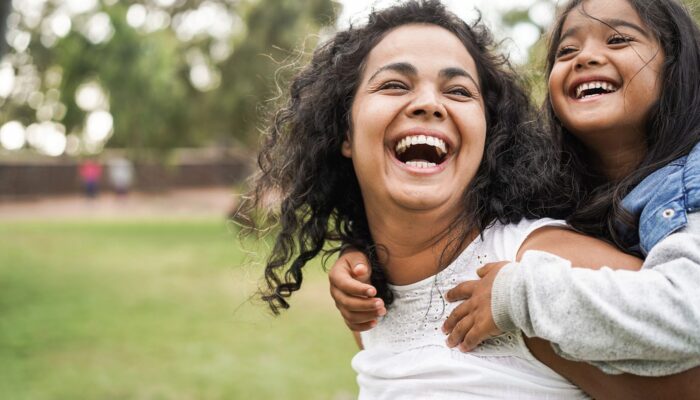 mother daughter smiling outdoors 7d884281db614313bf629048299e7384