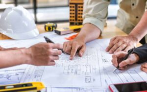 Team of construction contractors building out plans