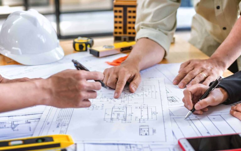 Team of construction contractors building out plans